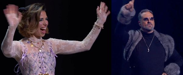 Two images: Laura as Jester on the left and Travis as Chetney on the right. 

LEFT: Laura dressed as Jester on a stage, smiling and waving at an off-screen crowd. She wears a lacy white and purple floral top whose bodice is tied with purple ribbons. She has two necklaces, one pearls and the other gold with shiny charms such as buttons. Black horns curl out from her brown hair. Rings adorn her fingers and a white pearly bracelet is on her left wrist. A gold belt bucket is just visible at the bottom of the image.

RIGHT: Travis dressed as Chetney standing straight on a stage, raising one finger as if pointing. He wears a gray fur shawl over a black turtleneck with gray fur cuffs. A silver necklace bearing a single curved tooth hangs over his chest. His eyes are visible behind dark shaded glasses. An earpiece is in his right ear.