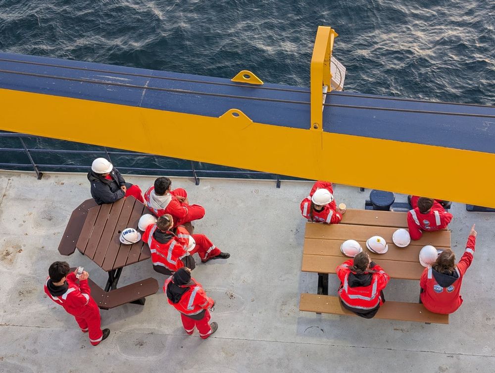 ESO and Science Team members are sitting on benches to enjoy the sunset on the port side of the L/B Robert, view from above. 