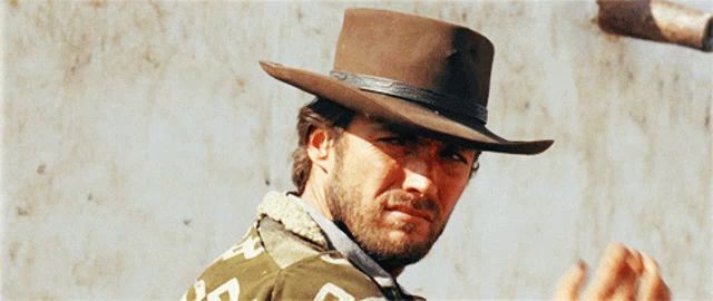 a man with a beard wearing a cowboy hat and a jacket that says ' a ' on the back