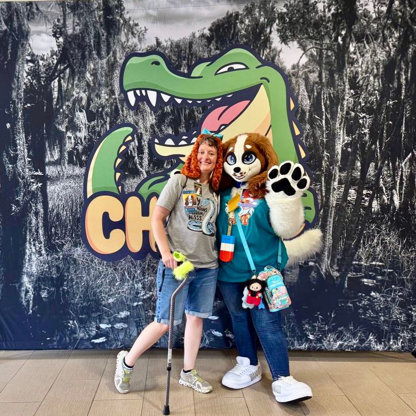 Me and Sunnie Spaniel posing in front of a backdrop featuring the logo for CHOMP