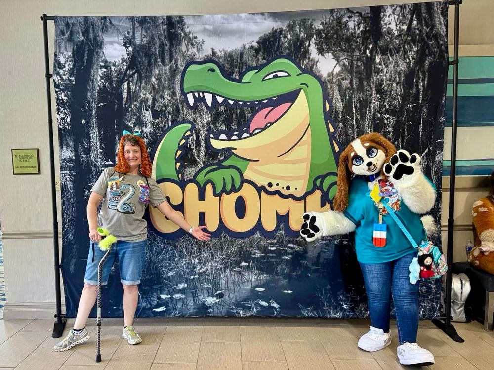 Me and Sunnie Spaniel posing in front of a backdrop featuring the logo for CHOMP