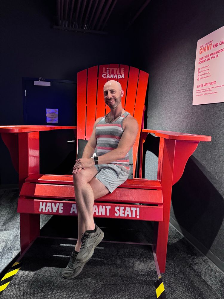Me on a big Adirondack chair at the Little Canada exhibit. 