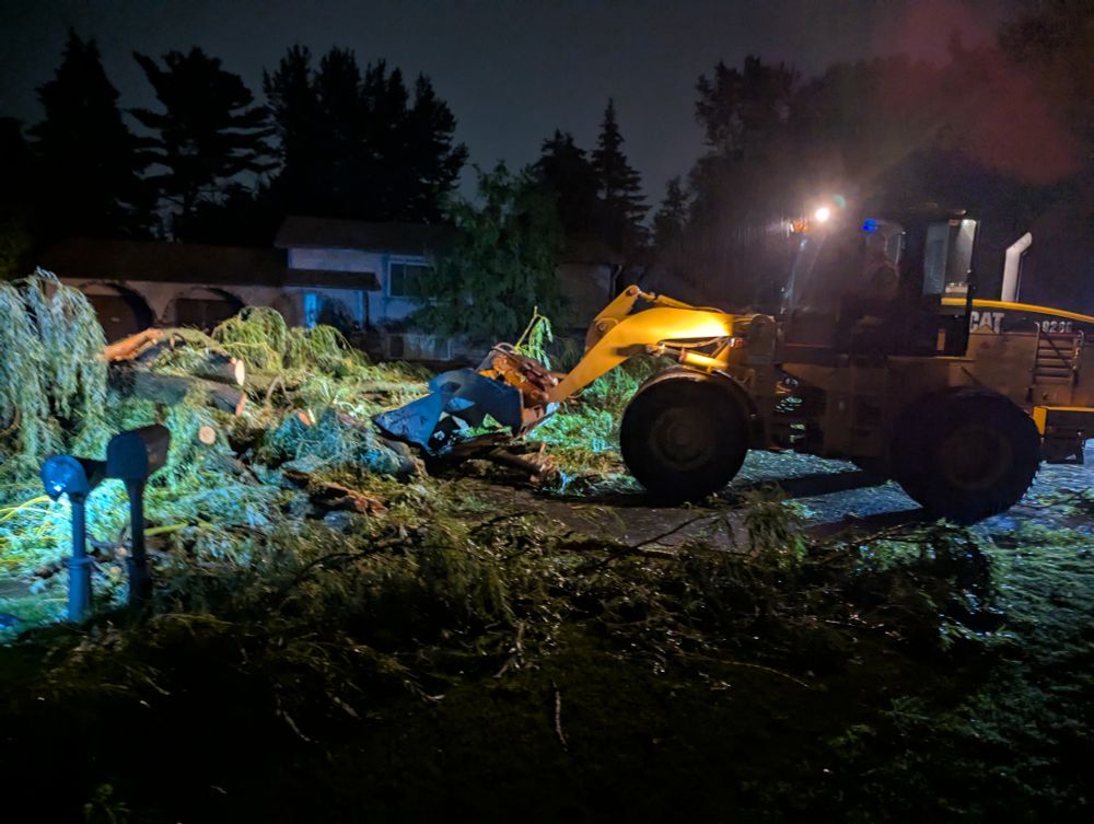 Front end loader working on moving my big ole willow tree out of the street. The cleared half of the street so neighbors can get by...