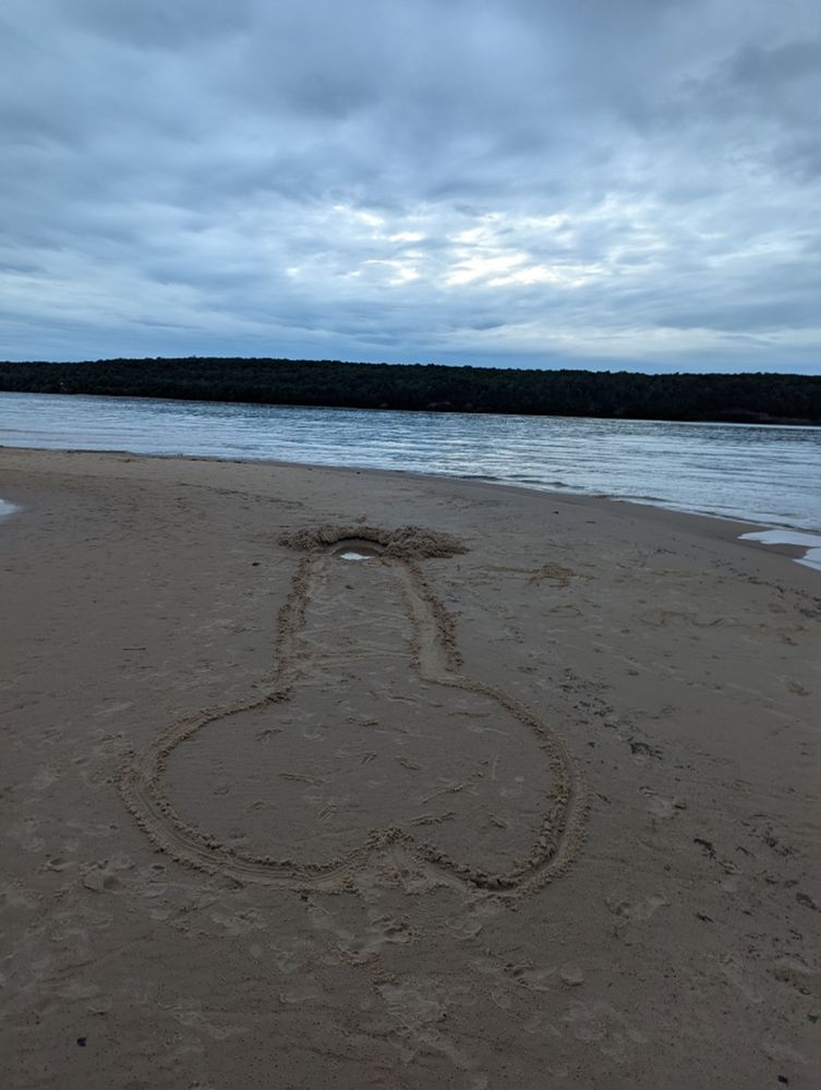 Picture a cloudy sunset across open water, a large island goes between Lake Superior and the cloudy sky. Then, in the foreground, some enterprising folk drew a 20' long penis in the sand, and excavated out the sand where the head of the penis would be... Art exists in unlikely places...