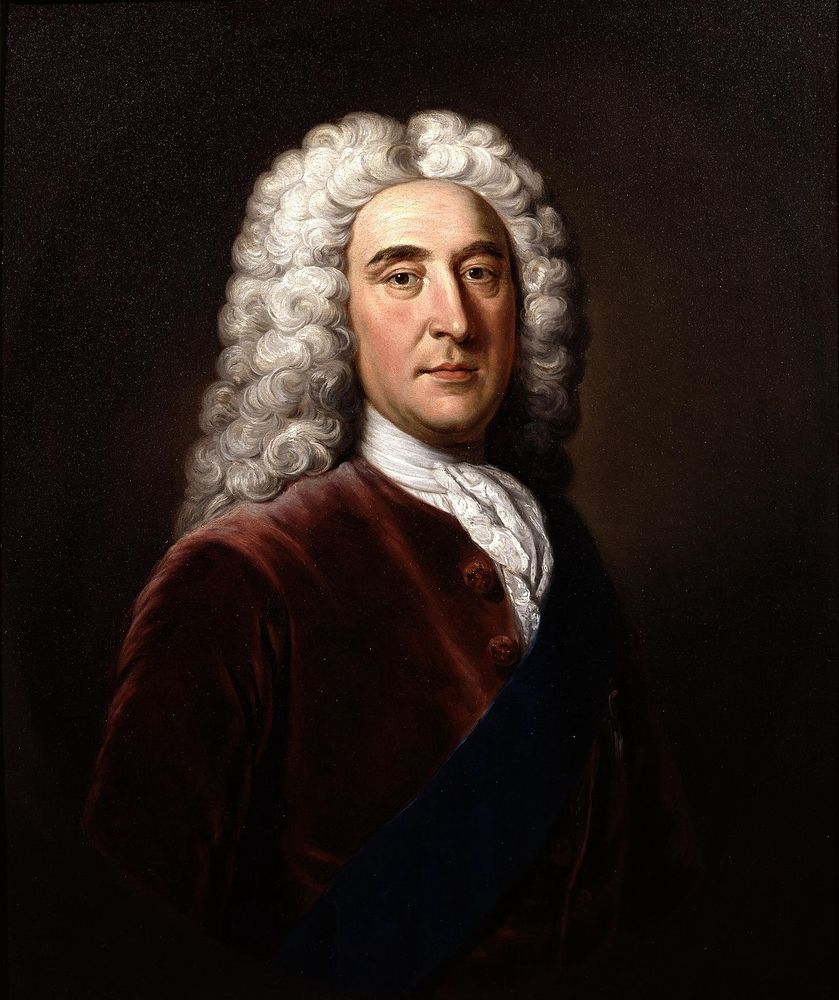 Painted portrait of Thomas Pelham-Holles, 1st Duke of Newcastle, by William Hoare. The Duke is clean shaven and wears a velvet coat of warm brown, the blue order of the garter sash lays across his chest. A lace cravat is tied neatly around his neck. His wig is white and curls behind his shoulders. The background is a dark brown. 