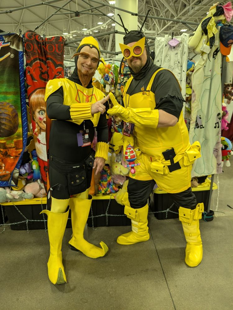 Two cosplayers dressed as The Monarch and Henchman Twenty One from Venture Bros.