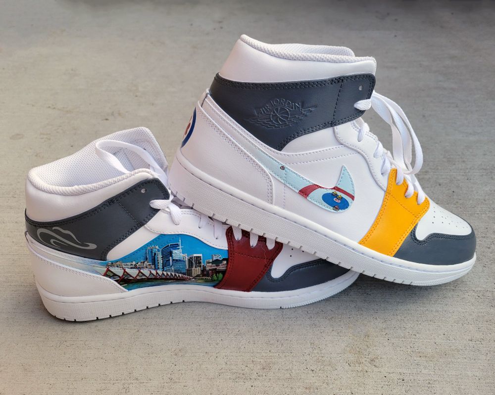 Nike Jordan shoes with a painting of down town Calgary and curling ice on the sides.
