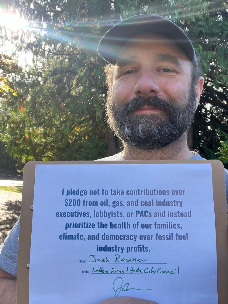 A bearded white guy in front of trees, smiling and holding a signed piece of paper: 

I pledge not to take contributions over $200 from oil, gas, and coal industry executives, lobbyists, or PACs and instead prioritize the health of our families, climate, and democracy over fossil fuel industry profits.

NAME Josh Roseneu
OFFICE Lake Forest Park City Council