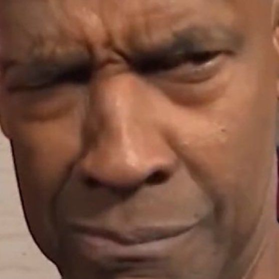 closeup of denzel washington with his brow furrowed in confusion.....suspicion? perhaps even disapproval...