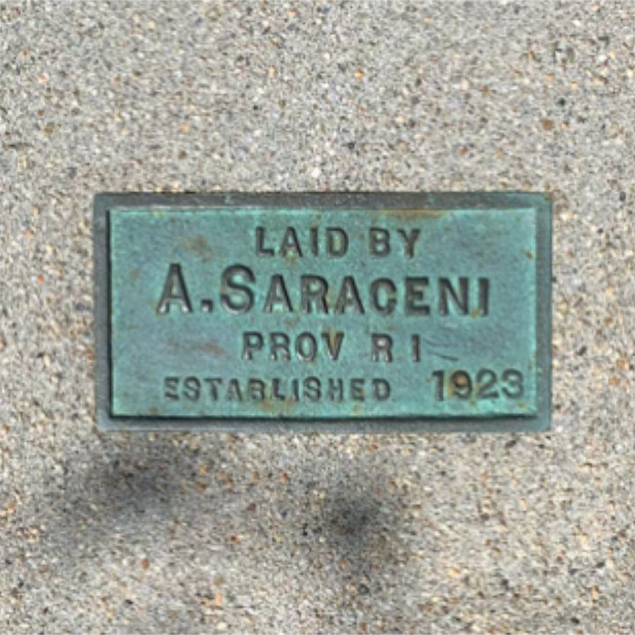 brass marker set in concrete: Laid by A. Saraceni, Prov. RI, established 1923
