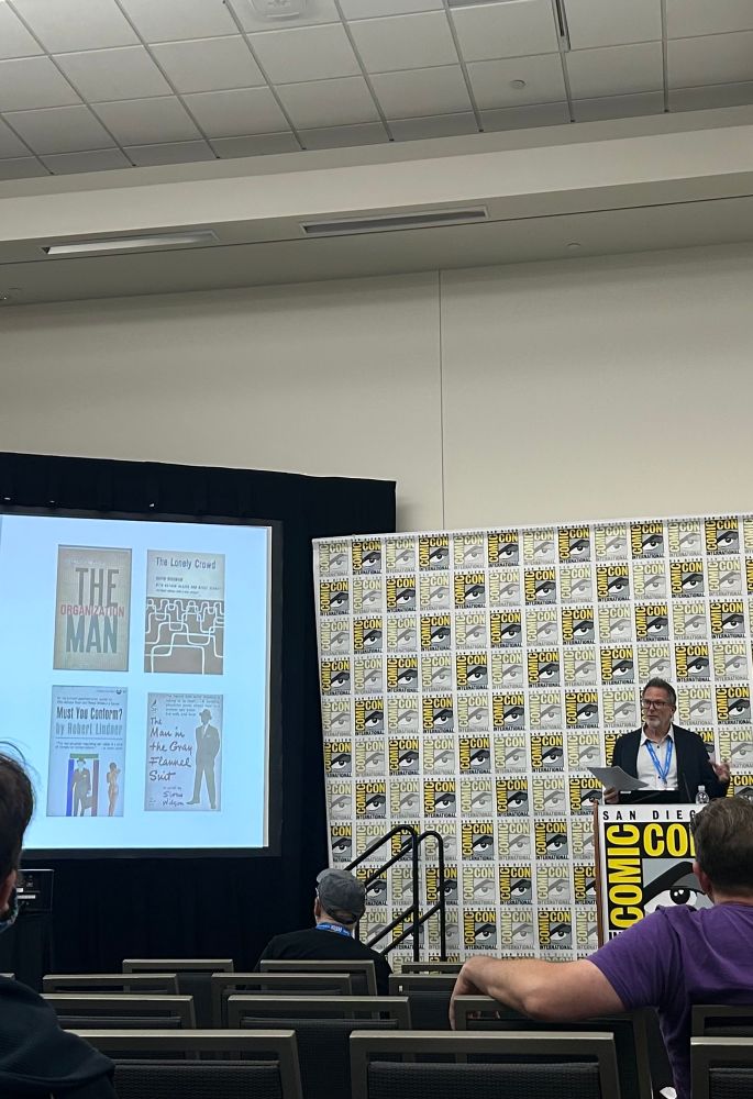 Me at a podium giving a talk about Bizarro and postwar American culture at comic-con 