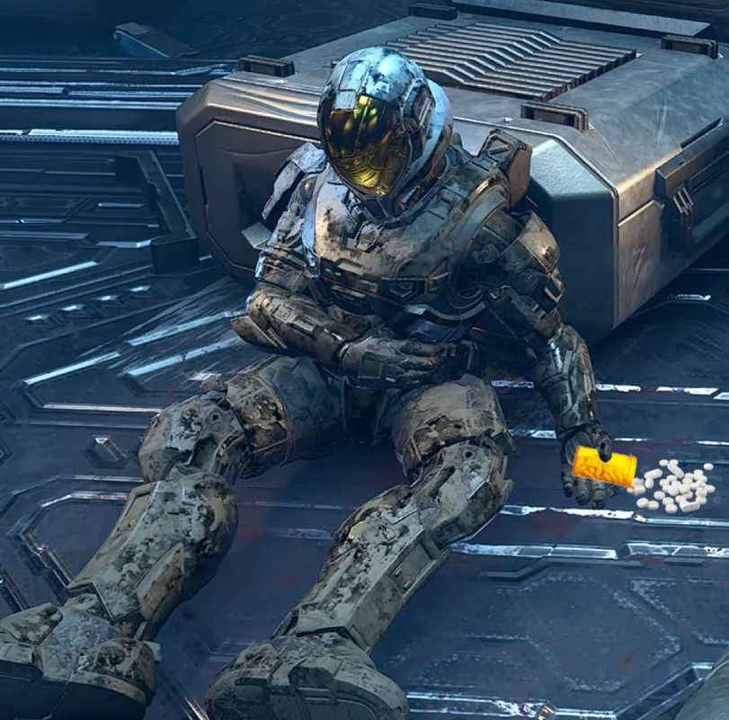 a dead spartan holding a spilled bottle of pills (343 has learned nothing)