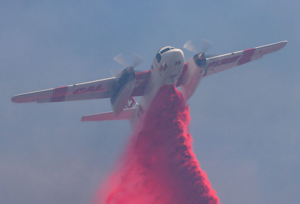 A CAL FIRE airtanker drops retardant.