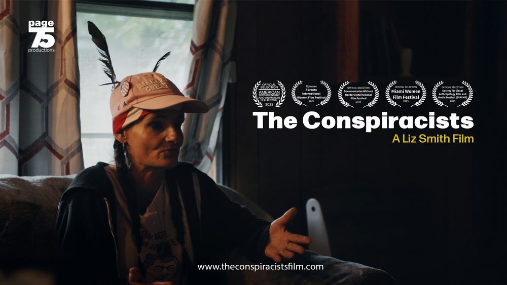 Promotional graphic for the documentary film The Conspiracists. On the left, a woman with long braids sits indoors, wearing a pink “Make America Great Again” cap with two feathers tucked in the back, a T-shirt, and a dark hoodie. She gestures with her hands while speaking. On the right side of the image are five white laurel graphics announcing film festival honors, including Official Selections at the American Documentary and Animation Film Festival (2025), Documentaries Without Borders International Film Festival (2025), Miami Women Film Festival (2025), and Society for Visual Anthropology Film & Media Festival (2025), along with a nomination at the Toronto International Women Film Festival (2025). Below the laurels, large white text reads “The Conspiracists,” with smaller yellow text beneath: “A Liz Smith Film.” At the top left is the Page 75 Productions logo. At the bottom center is the website address: www.theconspiracistsfilm.com.