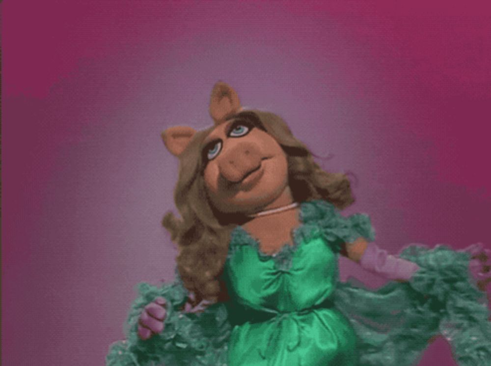 miss piggy is wearing a green dress and gloves