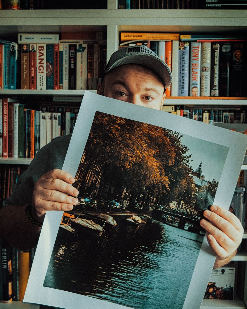 A photo of me holding a print from my digital store