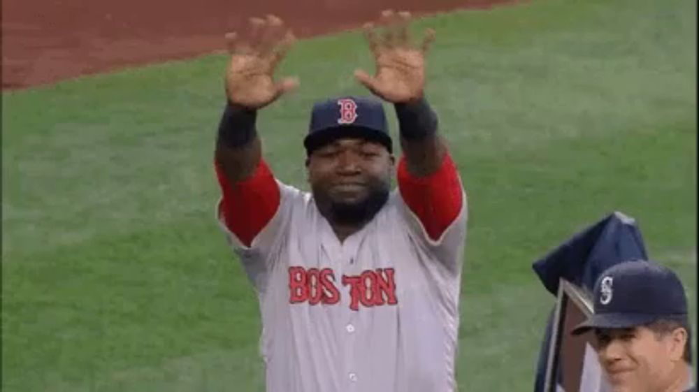 a man in a red sox uniform is standing on a baseball field .