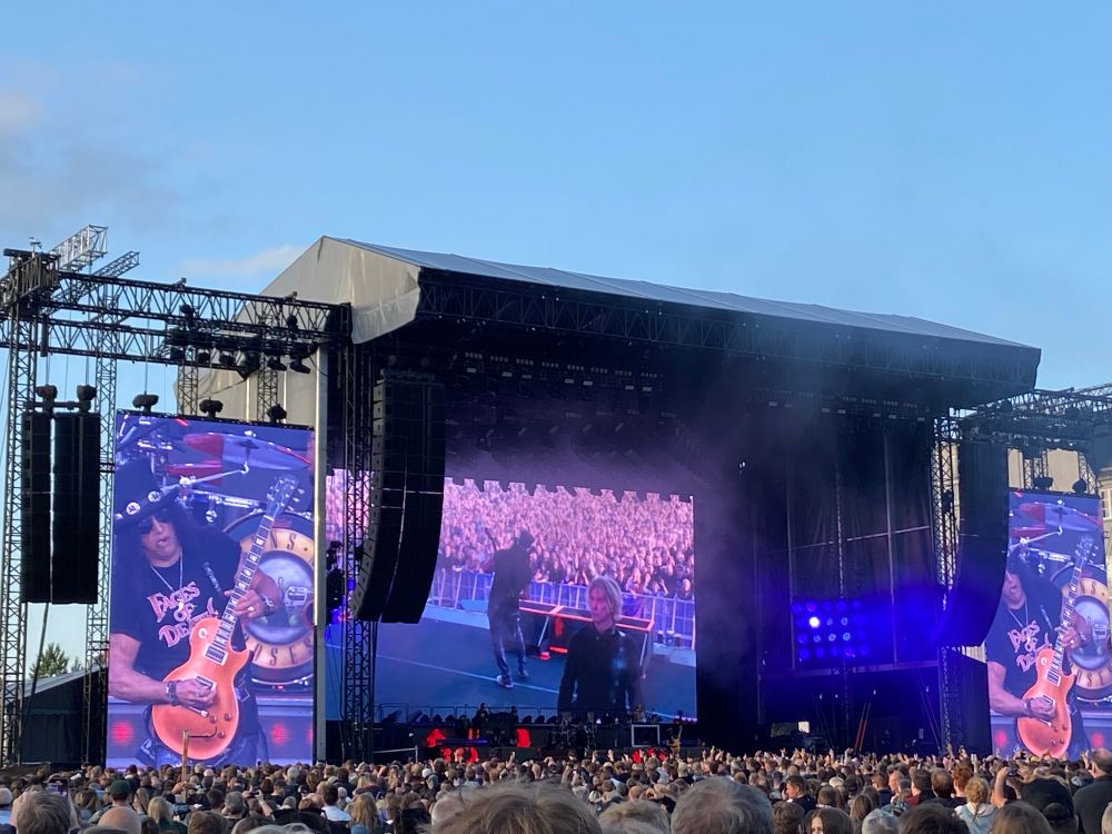 A view of the main stage of the Guns N‘ Roses concert. On both sides there are two huge screens currently depicting the guitarist Slash during a solo.