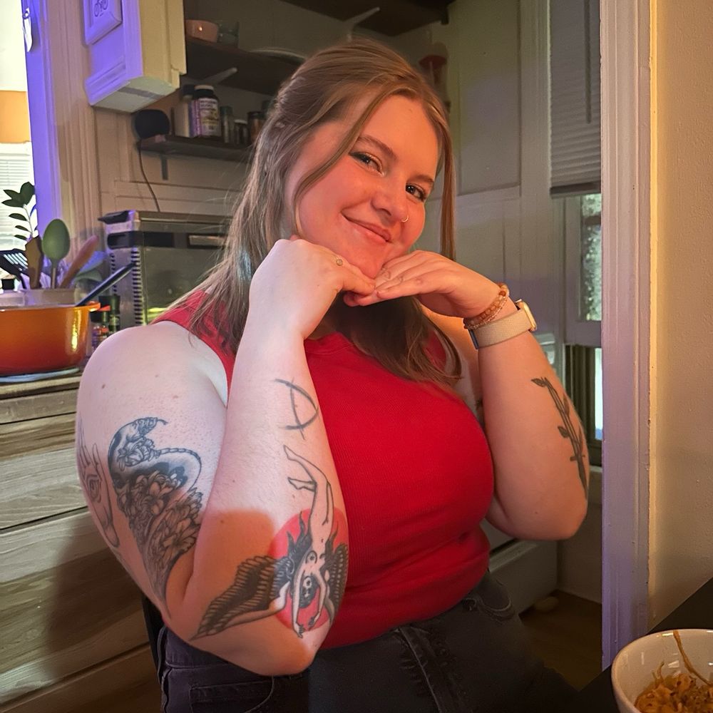 a picture of jori!! she is wearing a red tank top and black jeans