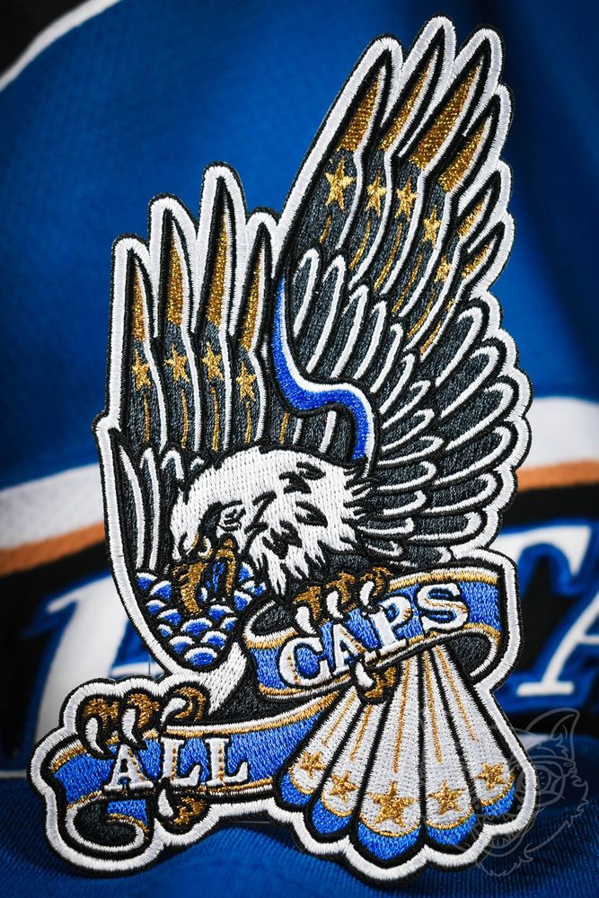 Embroidered patch with a blue, bronze, and black Caps-themed eagle