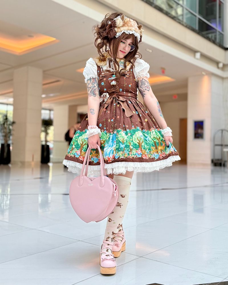 Rachel wearing a frilly brown dress with deer motifs 