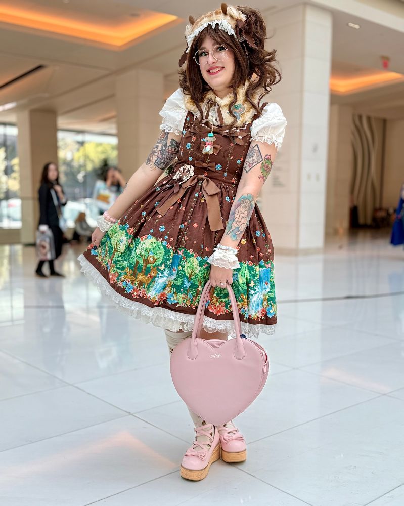 Rachel wearing a frilly brown dress with deer motifs 