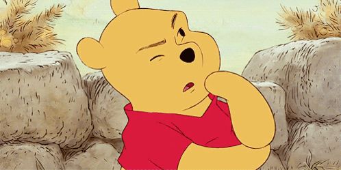 a cartoon of winnie the pooh with his eyes closed and a red shirt