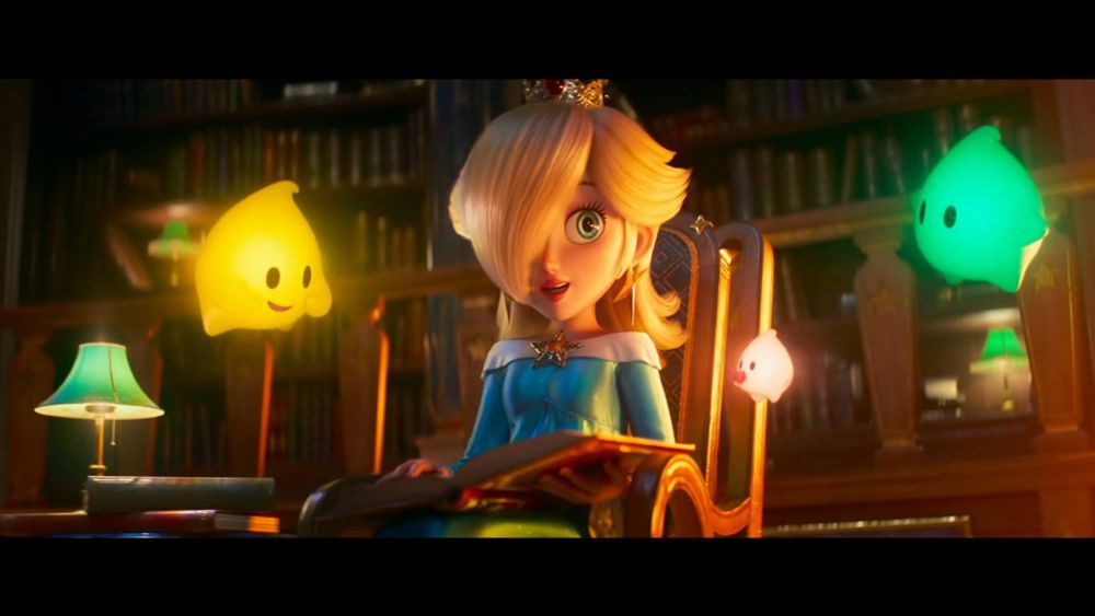 Fotograma del tráiler de la peli de Super Mario Galaxy con Estela leyéndole un libro a unos Destellos. 