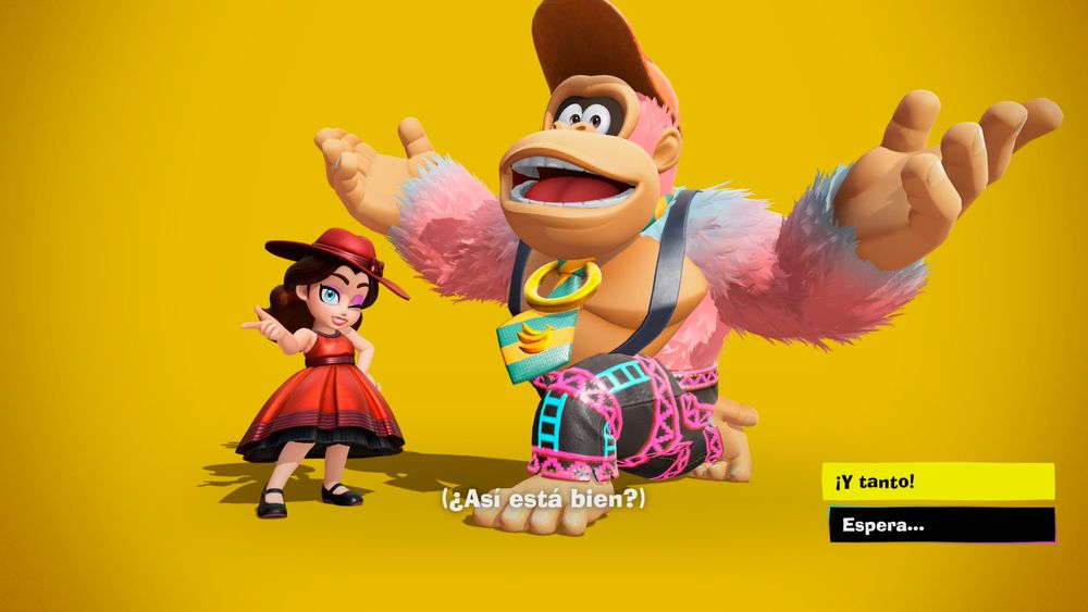 Captura del videojuego “Donkey Kong Bananza” con Donkey Kong y Pauline después de cambiarse en el vestidor. Él lleva un pelaje de degradado rosa-azul claro, pantalones inspirados en los andamios y escaleras del DK original y una corbata amarilla y azul a rayas. Ella lleva un vestido rojo y negro muy elegante inspirado en el traje de cantante de Pauline de adulta.