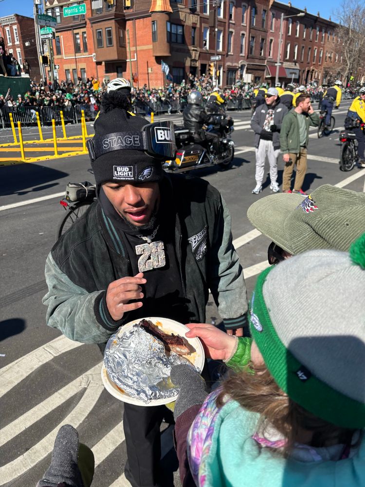 Saquon Barkley being offered a plate of ribs