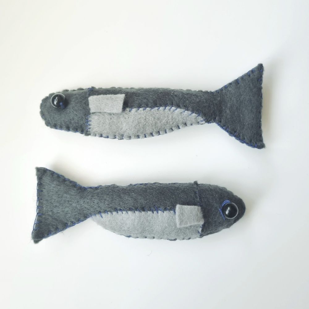 two plush anchovy made of felt and a bead eye.
