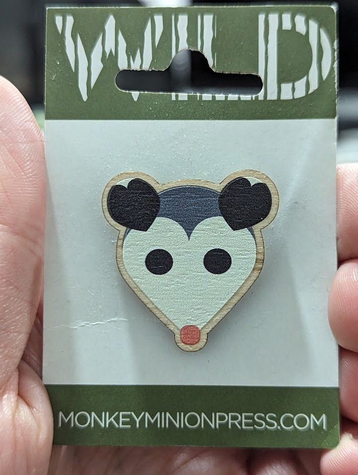 A photo of a pin in the shape of a possum from monkeyminionpress.com 