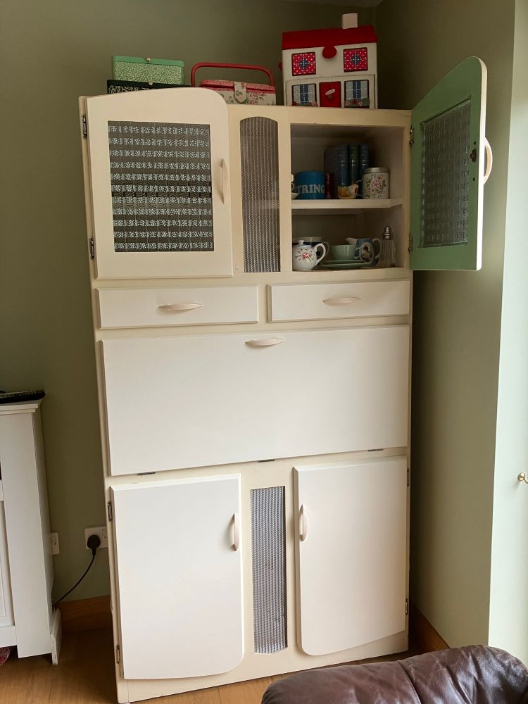 Vintage, cream painted larder cupboard from, I think, the 40s, maybe earlier. Patterned glass top doors & metal grills for air flow. 