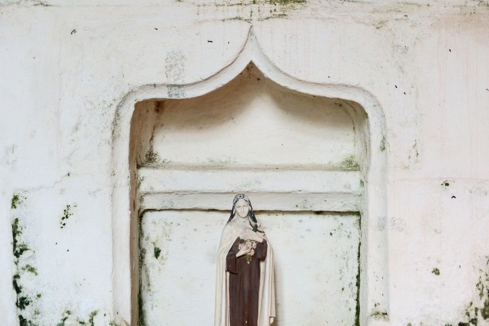 a small figure in a niche