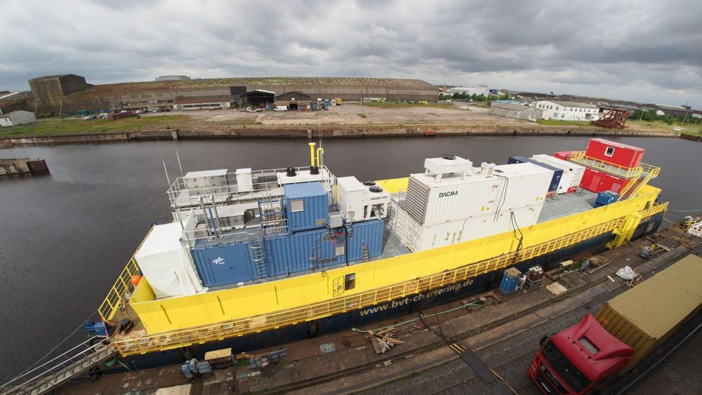 Floating platform with modular container facility for the offshore production of synthetic fuels from wind energy, seawater, and ambient air.