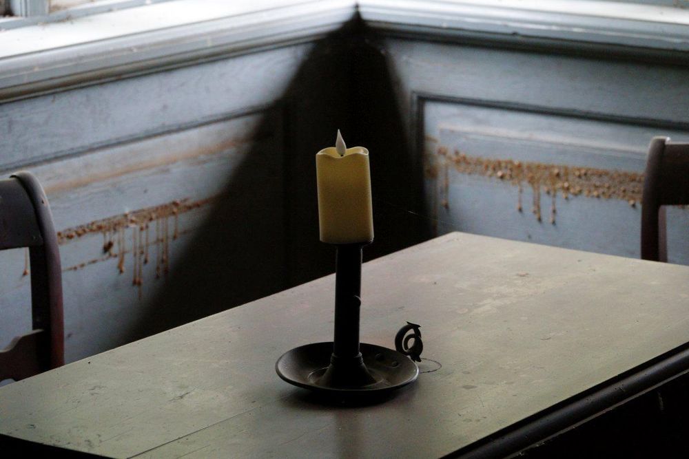 a candle on an old table