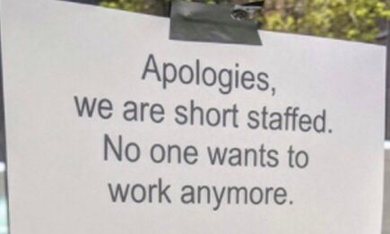 A sign is taped to a door that says Apologies, we are short staffed. No one wants to work anymore.