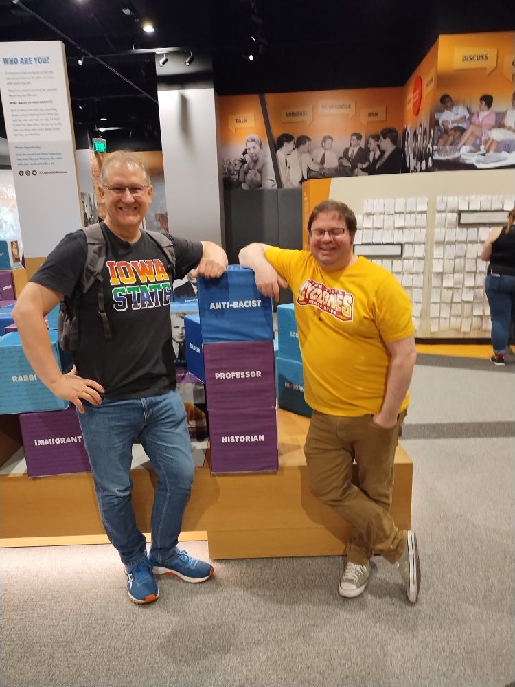 Photo of Profs. Best and Behnken standing in front of descriptive blocks at the CJM.