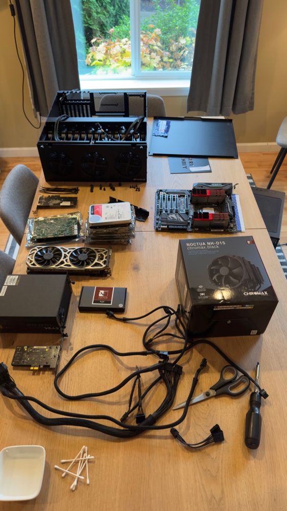 Computer components laid out on a wooden table during a server build