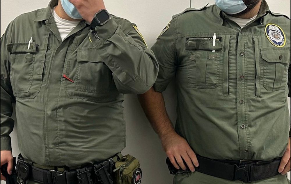 ICE use pens to hold up their shirt pocket flaps, to hide their names. Waiting in San Diego courthouse to grab immigrants attending hearings. Criminals 