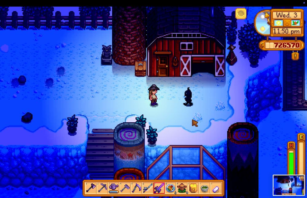 A Stardew Valley screenshot, in the winter at night on a farm. The player character, me, is facing a shadow monster by the barn.