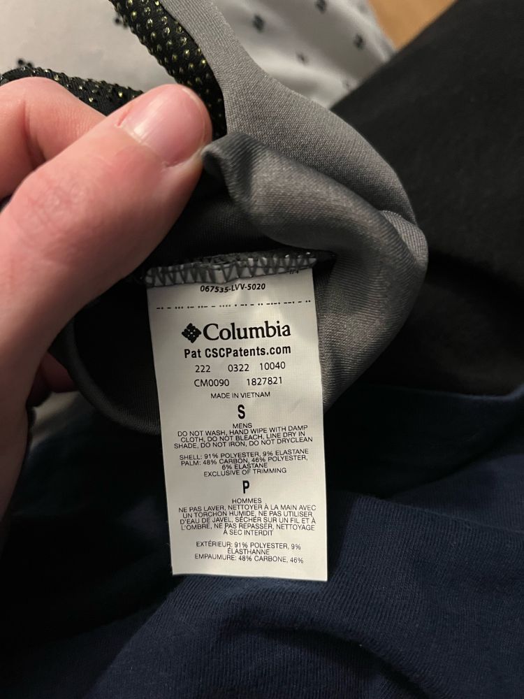 A photo of a tag inside a glove that inexplicably has something Morse code-like across the top