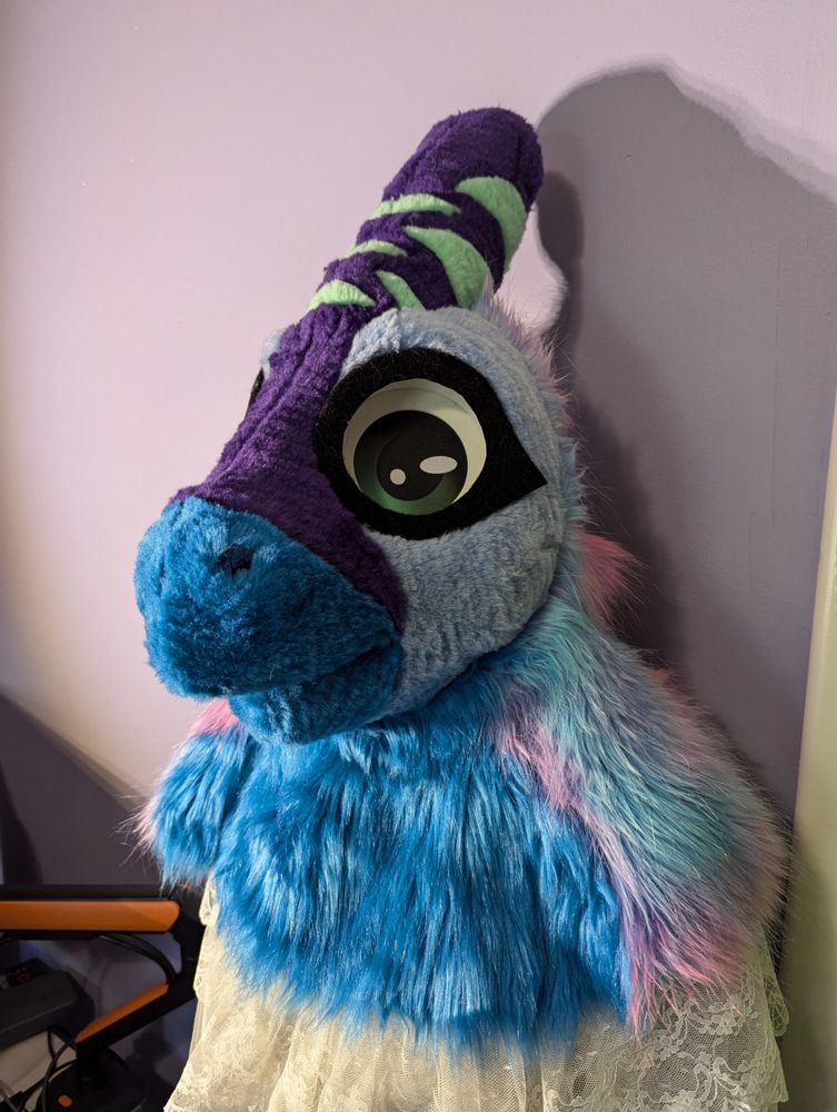 an image of a blue parasaur fursuit head