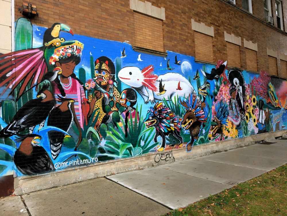 A mural featuring animals and Latinx people, in Little Village, Chicago.