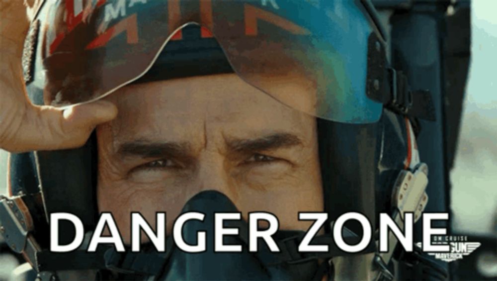 a man wearing a helmet has the word danger zone written on his face