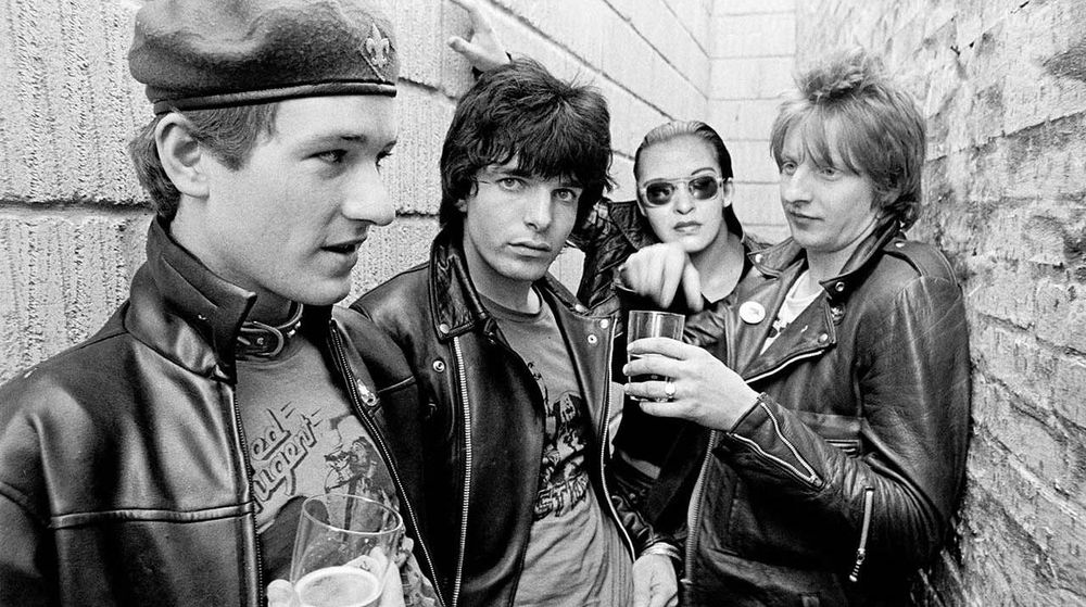 Black and white photo of punk rock band The Damned in 76 0r 77 but with Billie Holiday's face replacing singer Dave Vanian's.