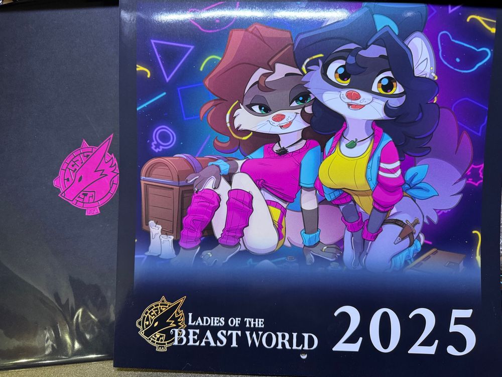 On the right, a 2025 calendar entitled Ladies of the Beast World. The calendar features two raccoon ladies in late 80s/early 90s workout wear. Various secret emblems are sprinkled throughout the picture.
On the left, a black envelope with an embossed logo hiding its secrets from prying eyes.