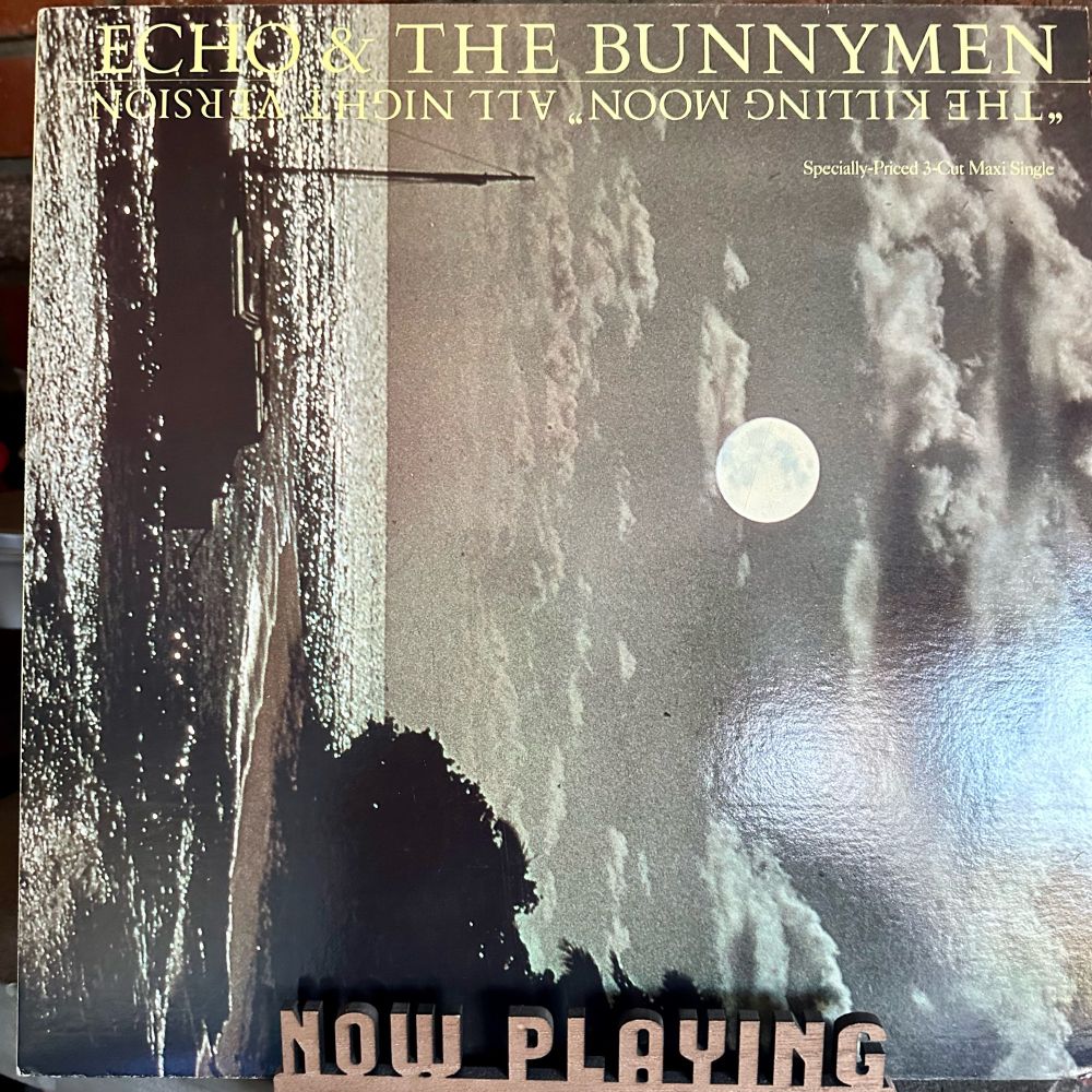 Jacket for the 12” single on a now playing stand. 