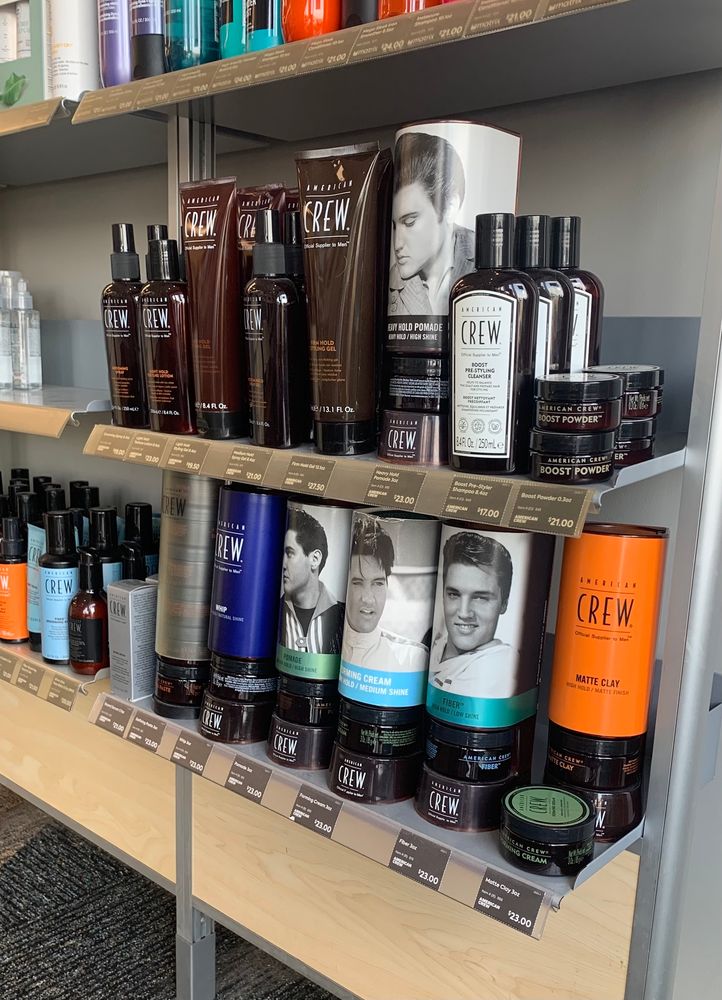Hair product sales rack at a hair salon. Several of the product displays bear Elivs’ likeness. 