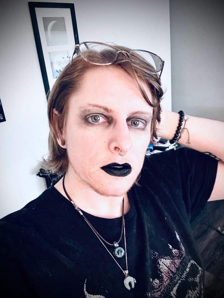 A selfie. I’m dressed up goth with black lipstick, messy black eyeshadow, and a black shirt. 